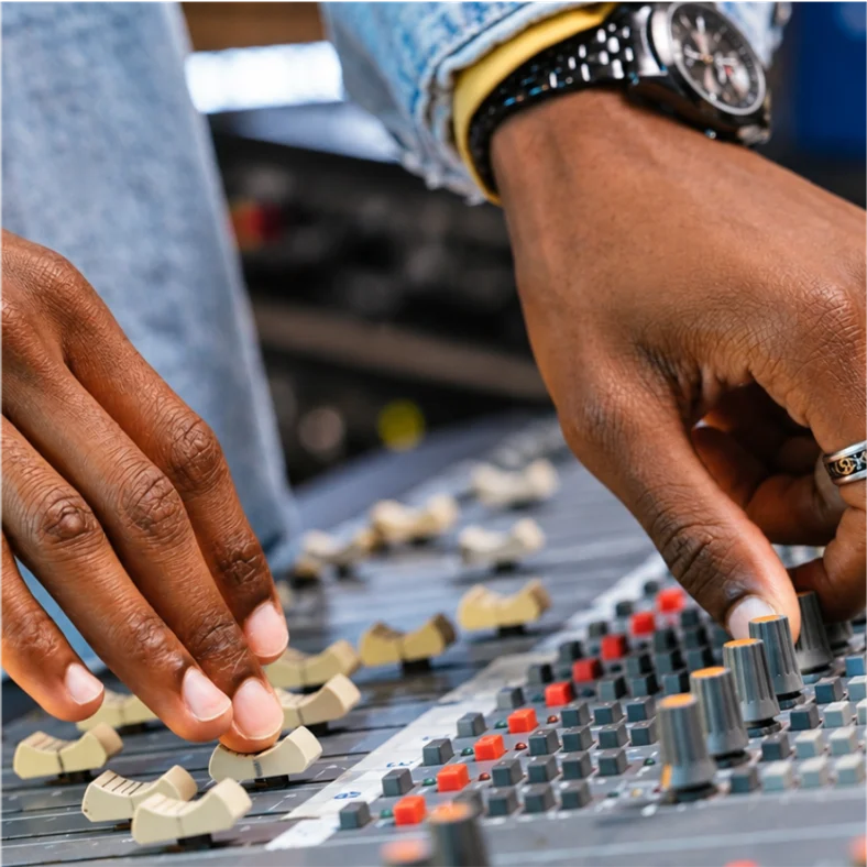 A musician at a mixing desk